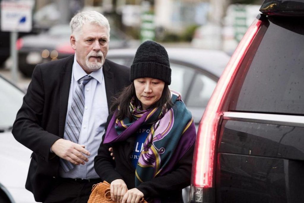 Huawei chief financial officer Meng Wanzhou arrives at a parole office with a security guard in Vancouver on Dec. 12, 2018